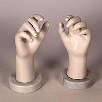 A pair of marble mounted mannequin hands.